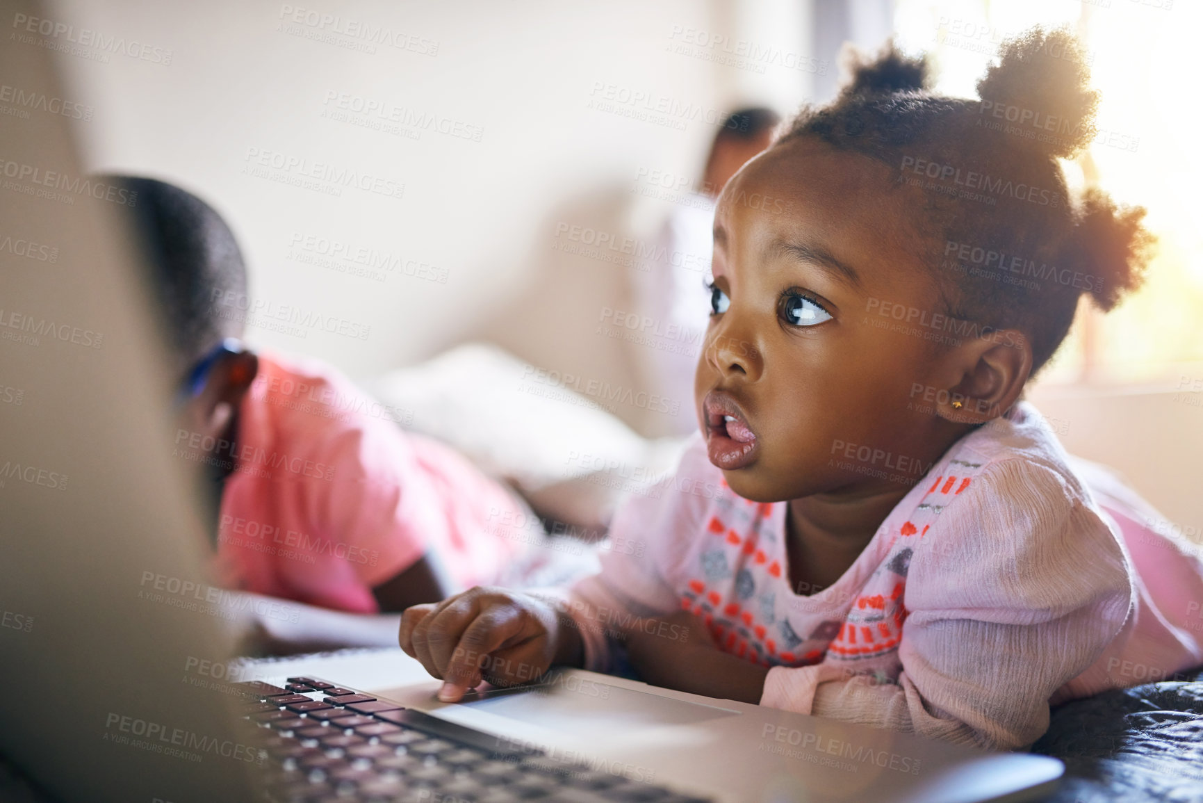 Buy stock photo Girl child, online and relax with laptop in home for creative activities, learning and streaming movies. Toddler, internet and technology for curiosity or engaging for education growth or development