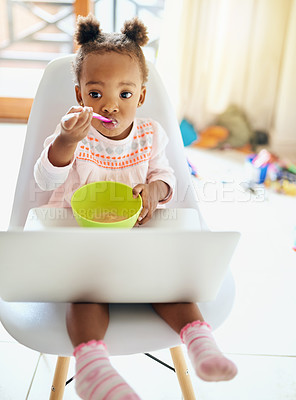 Buy stock photo Cropped shot of an adorable little girl eating breakfast at home