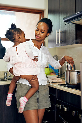 Buy stock photo Black family, mom and cooking with baby in kitchen for food, meal or lunch together at home. African mother, young child or hungry kid with pot on stove for dinner, snack or preparation at house