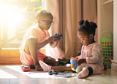 Buy stock photo Black child, little girl and siblings playing with toys together on floor in living room at home. Young African, baby or toddler with playful brother for bonding, creativity or building help at house