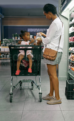 Buy stock photo Black family, mother and baby with shopping trolley in cart together at grocery store. African mom with daughter, child or girl in shop carriage for ingredients or commerce at indoor supermarket