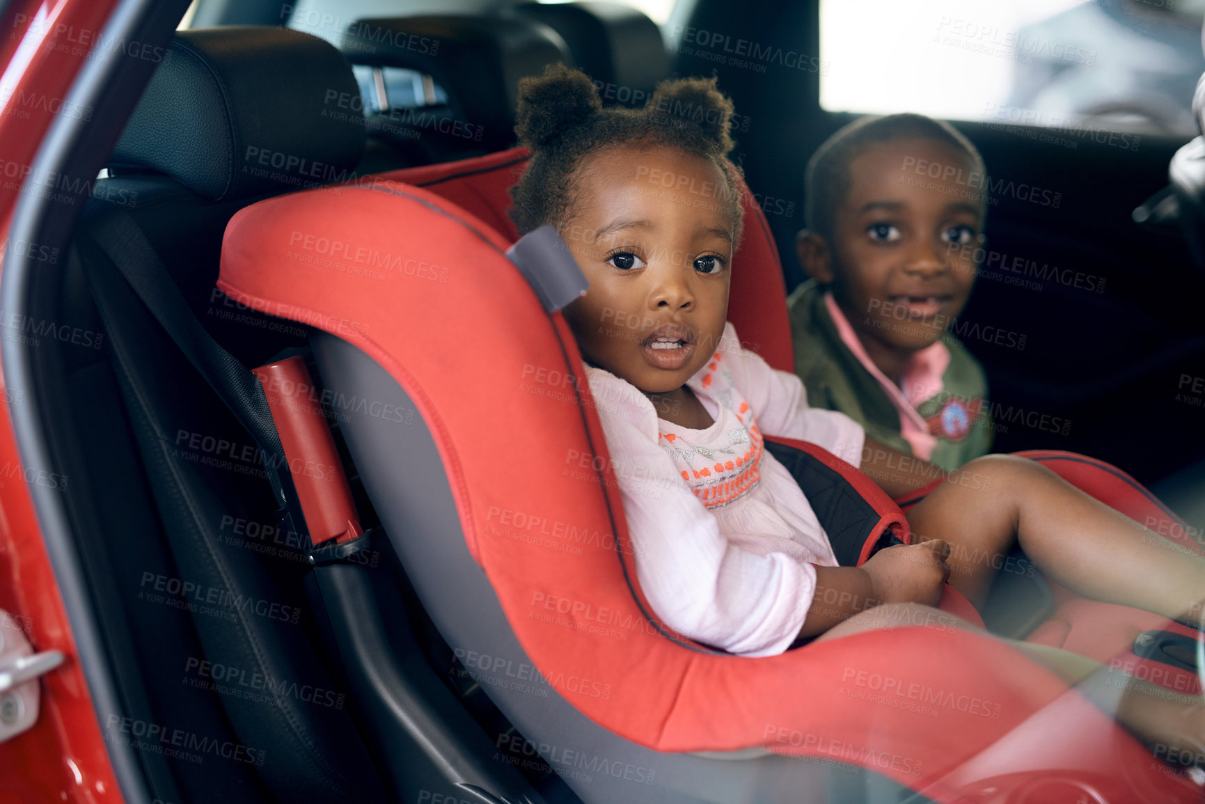 Buy stock photo Cropped portrait of a young brother and sister sitting in a carseat