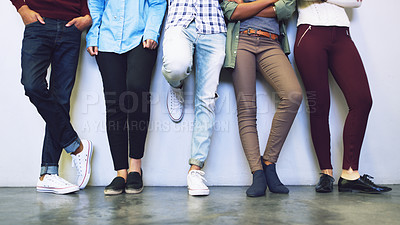 Buy stock photo Cropped shot of a group of unrecognizable university students standing in a corridor on campus