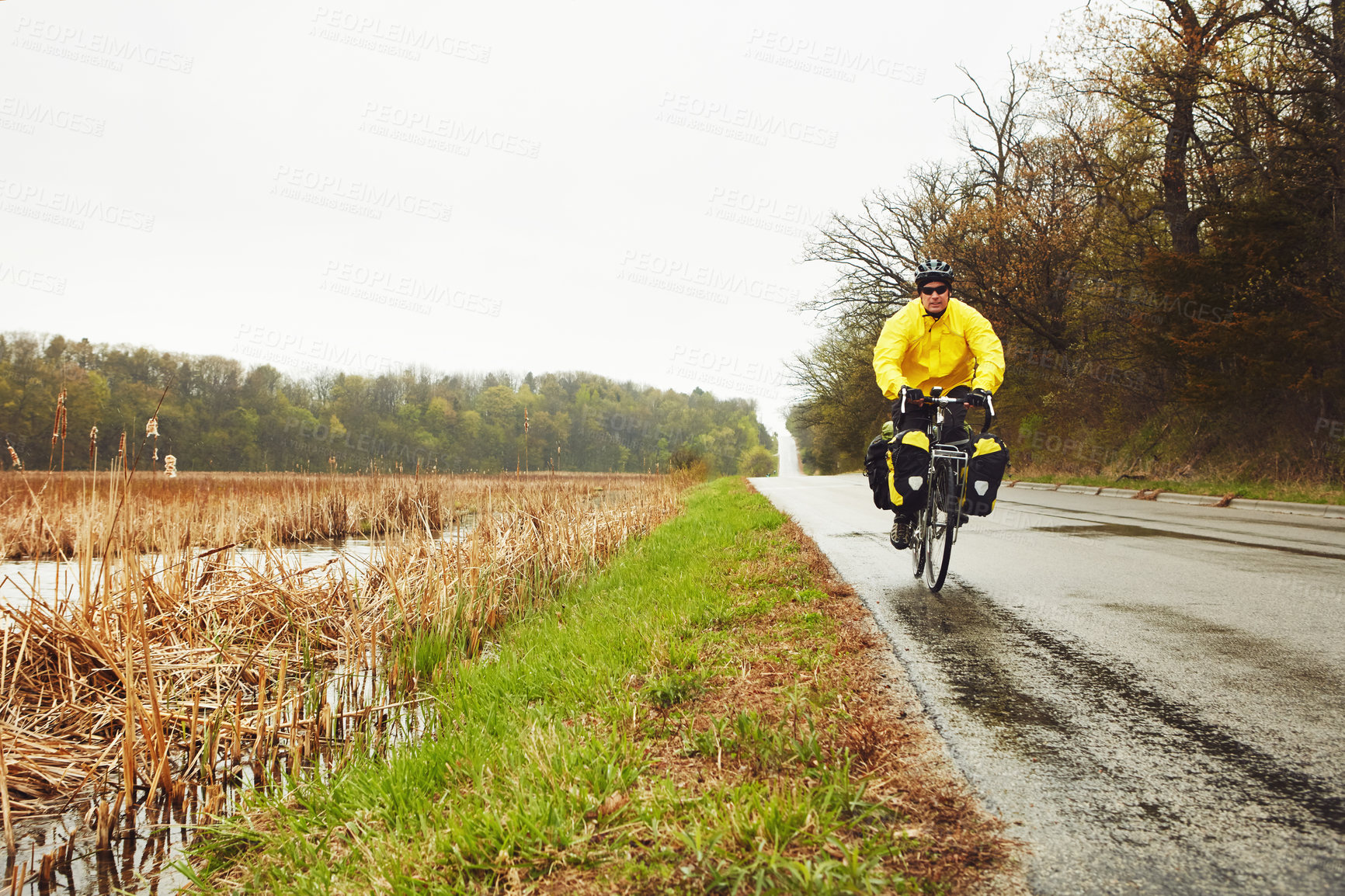 Buy stock photo Man, cyclist and bicycle in nature for fitness, exercise and endurance challenge. Space, mature person and cycling with bike for training, workout safety and rain weather of physical activity outdoor