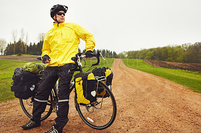 Buy stock photo Cropped shot of a male cyclist enjoying a bike ride on a wet winter's morning