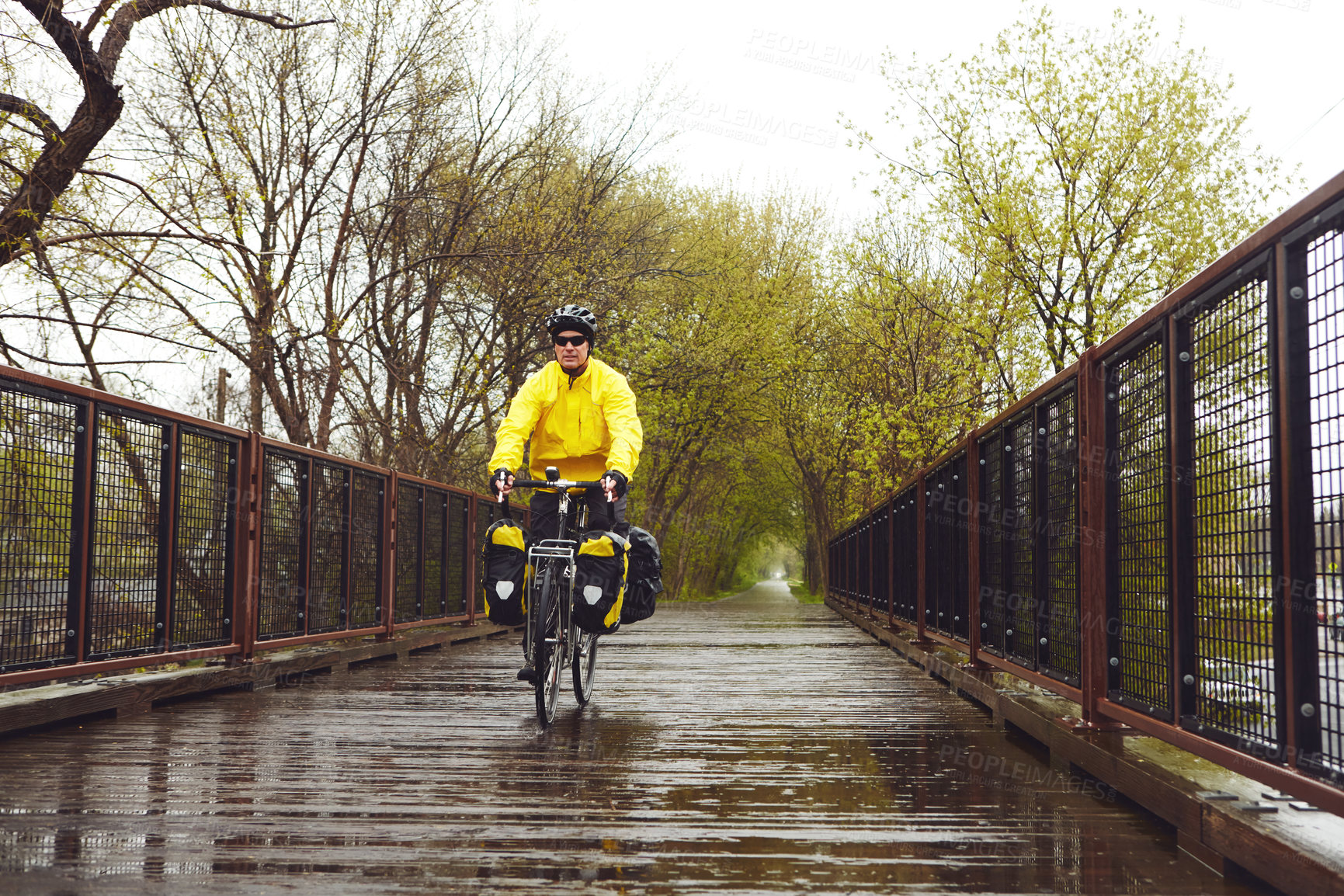 Buy stock photo Bridge, sports and man on bicycle for exercise, active hobby and training in winter in park. Fitness, outdoor and person on bike for cycling, workout and endurance for wellness, practice and health