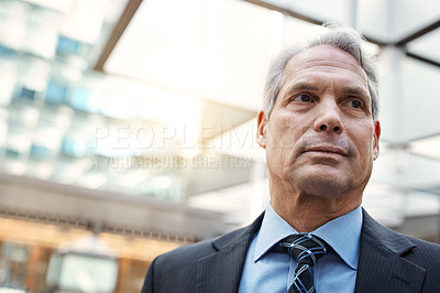 Buy stock photo Low angle shot of a confident mature businessman in a modern office