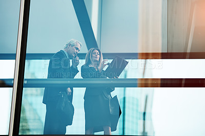 Buy stock photo Shot of a businessman and businesswoman working together in a modern office