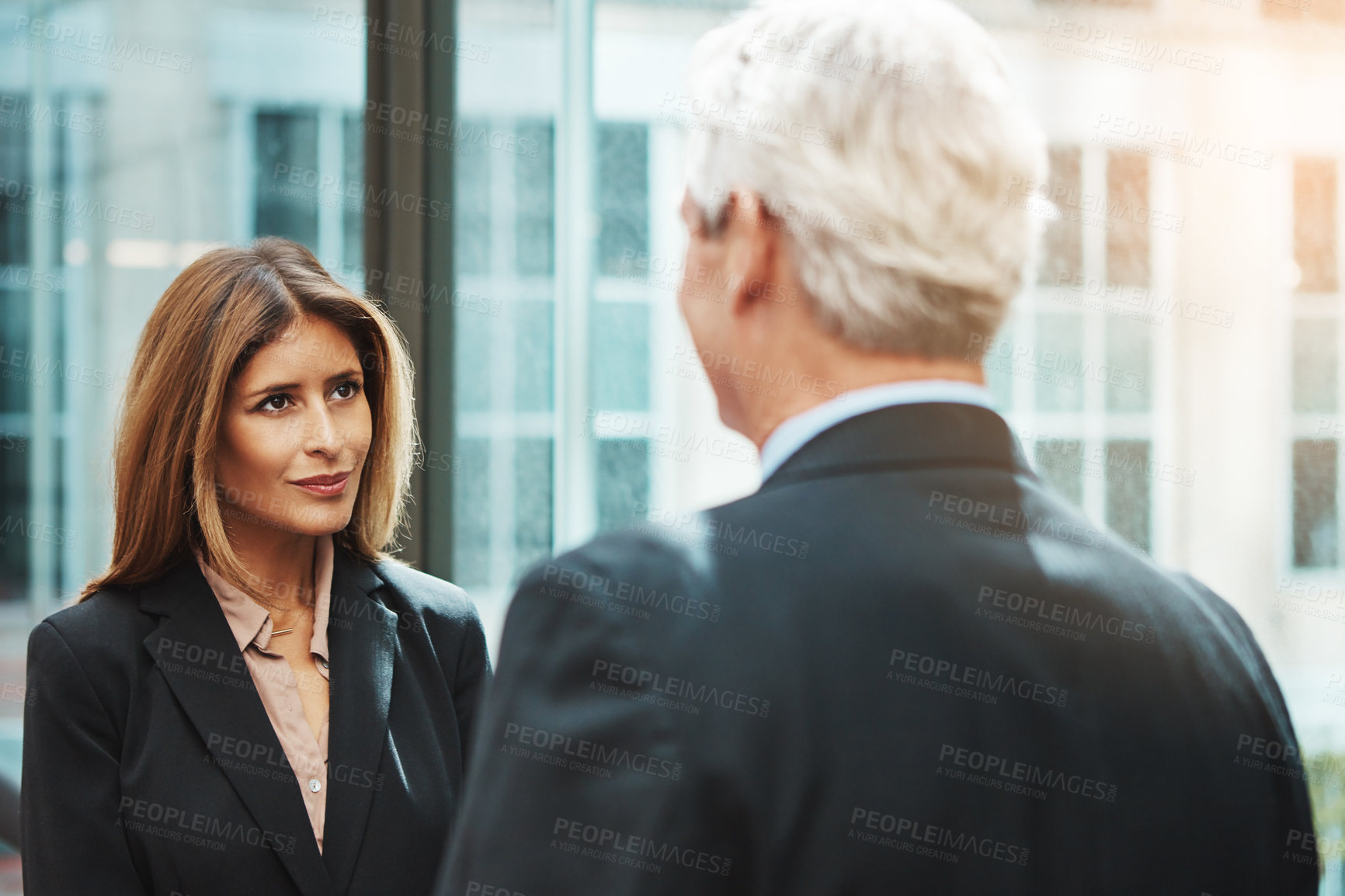 Buy stock photo Shot of a businessman and businesswoman having a discussion in a modern office