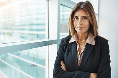 Buy stock photo Portrait of a confident businesswoman standing in a modern office