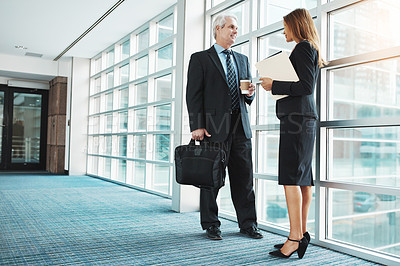 Buy stock photo Shot of a businessman and businesswoman having a discussion in a modern office