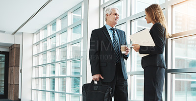 Buy stock photo Shot of a businessman and businesswoman having a discussion in a modern office