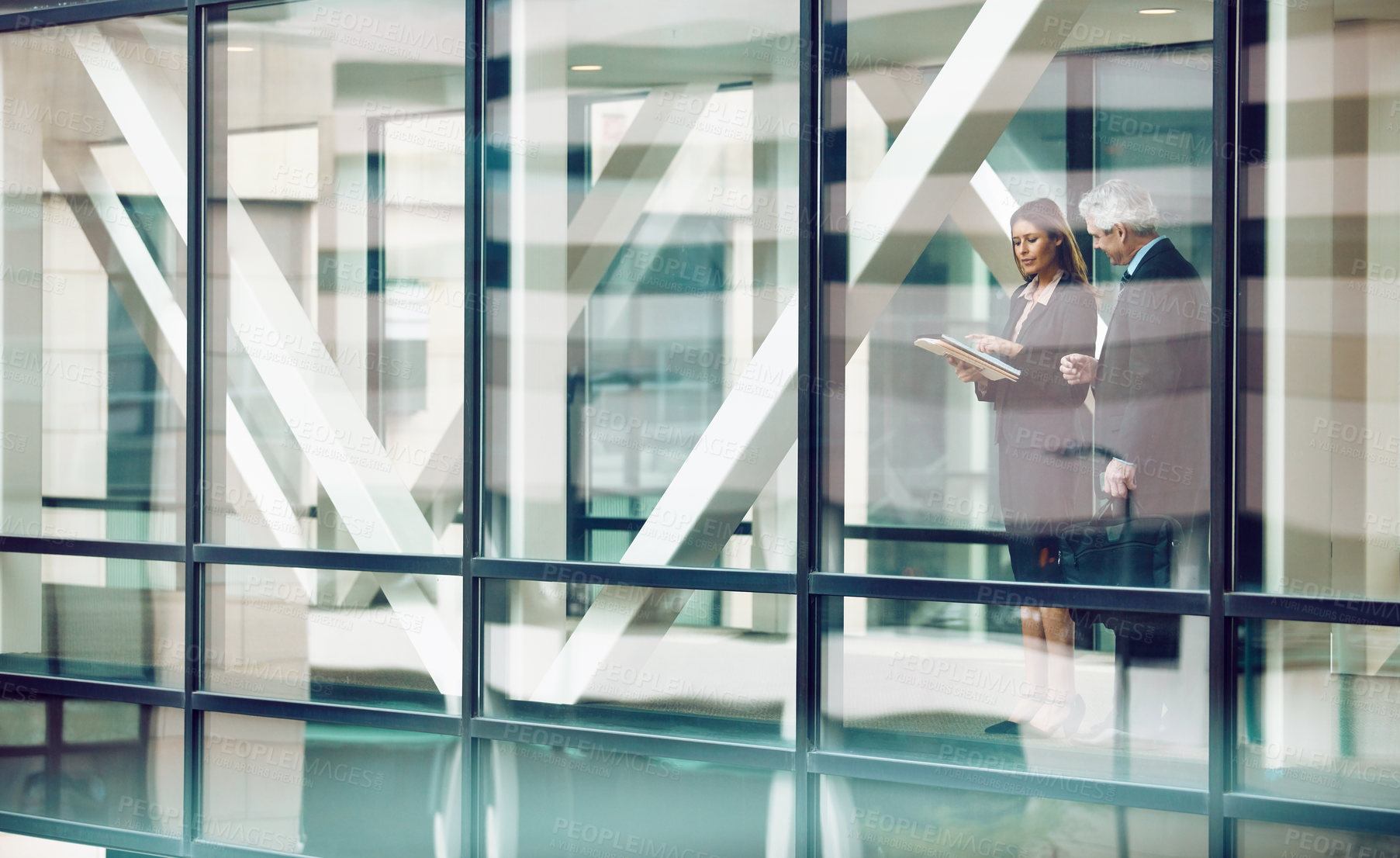 Buy stock photo Shot of a businessman and businesswoman having a discussion in a modern office