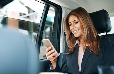 Buy stock photo Shot of a mature businesswoman using a mobile phone in the back seat of a car