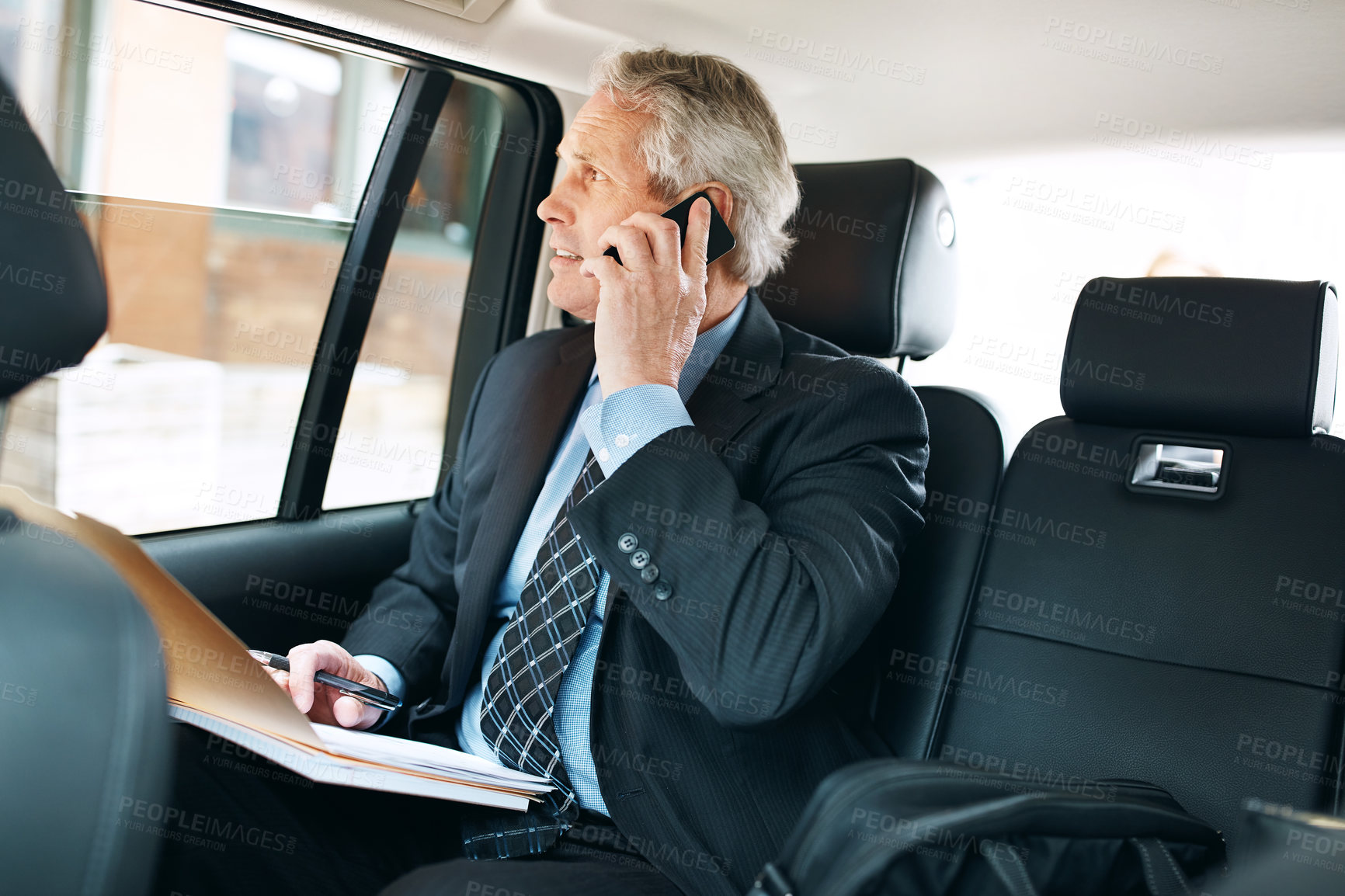 Buy stock photo Phone call, mature man and mobile in taxi for commute, schedule meeting, communication in backseat. Business, transport and employee with paperwork for conversation, discussion or travel in vehicle