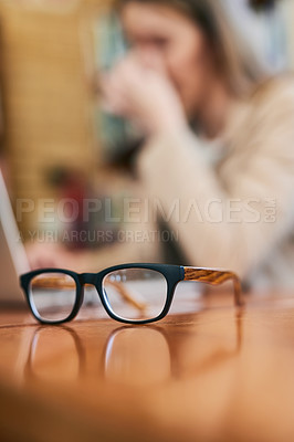 Buy stock photo Shot of a pair of glasses on a table indoors
