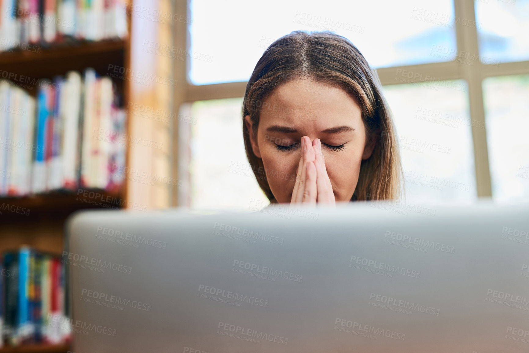 Buy stock photo Prayer, library and woman with laptop, hope and fatigue and overtime on research project at university. Stress, thinking and tired college student with deadline, study schedule and online education