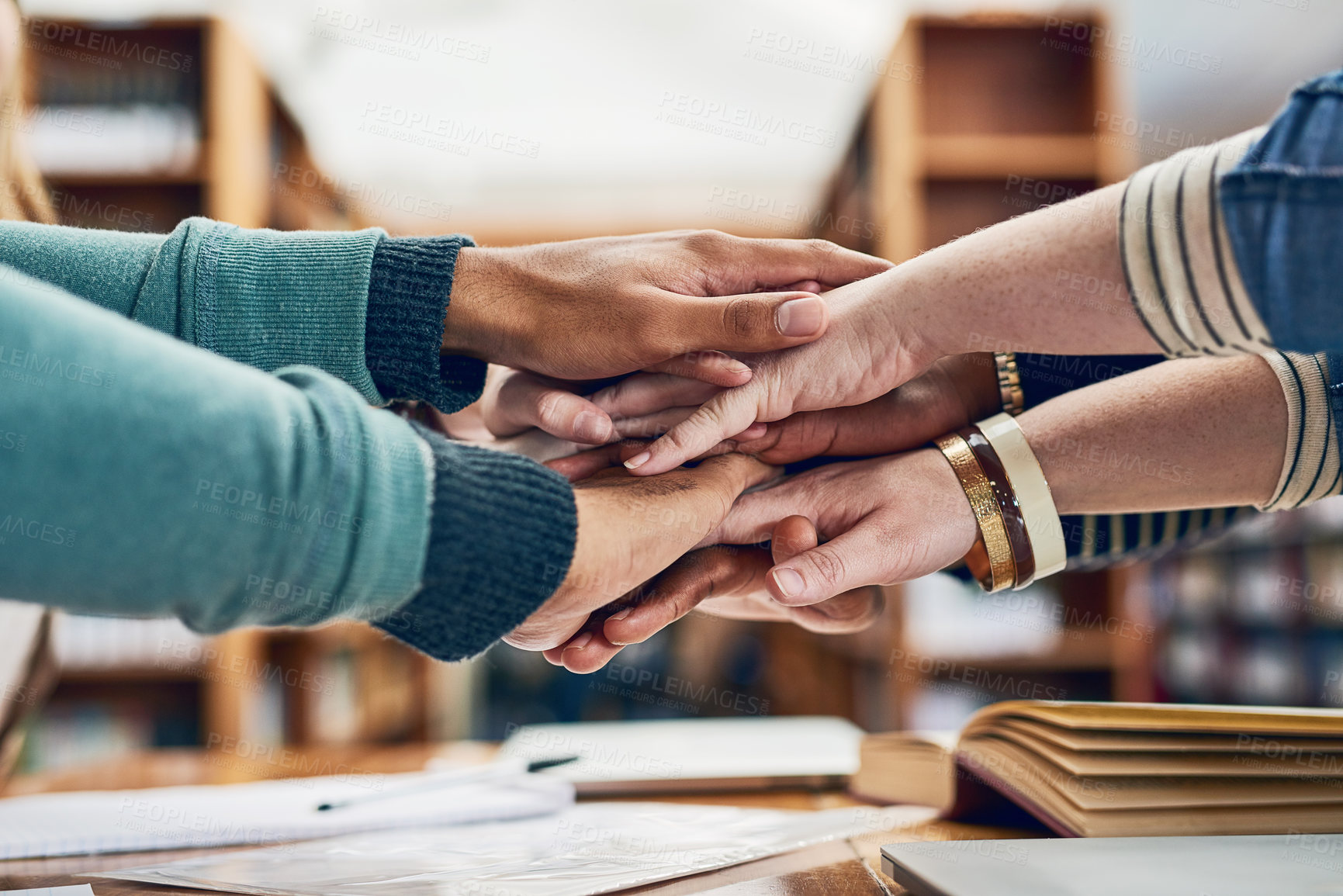 Buy stock photo Hands, stack and group of students with motivation, books or solidarity for goals, exam or education. People, huddle or scrum with team, trust and study for development in library, hall or university