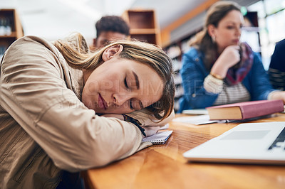 Buy stock photo Woman, student and sleep at college with group, burnout and tired with books, tech and education in library. Person, fatigue and exhausted with studying, learning or development in hall at university