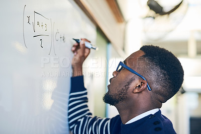 Buy stock photo Cropped shot of a young man writing on a whiteboard in a classroom