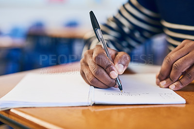 Buy stock photo Cropped shot of a university student writing in her notebook