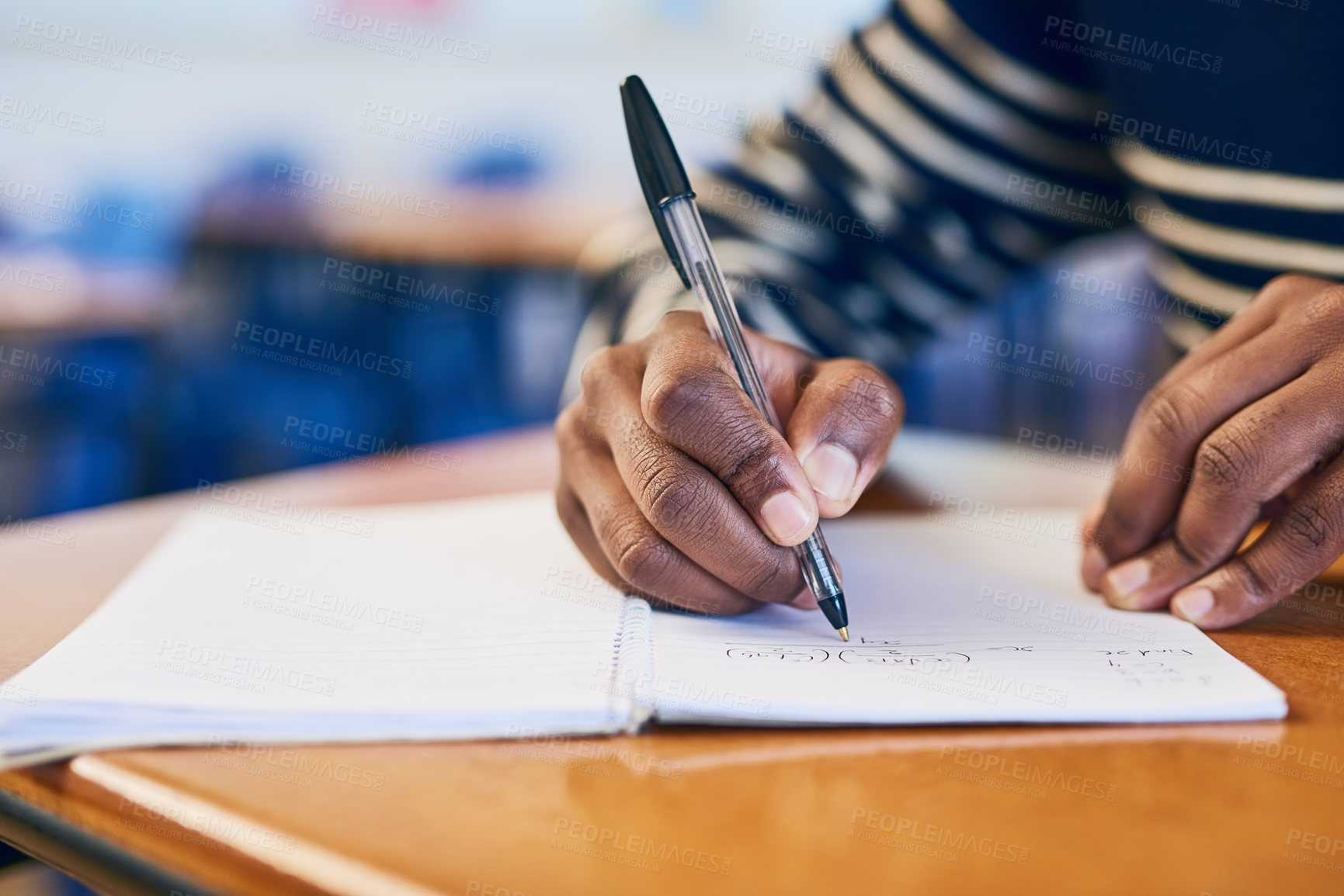 Buy stock photo Cropped shot of a university student writing in her notebook