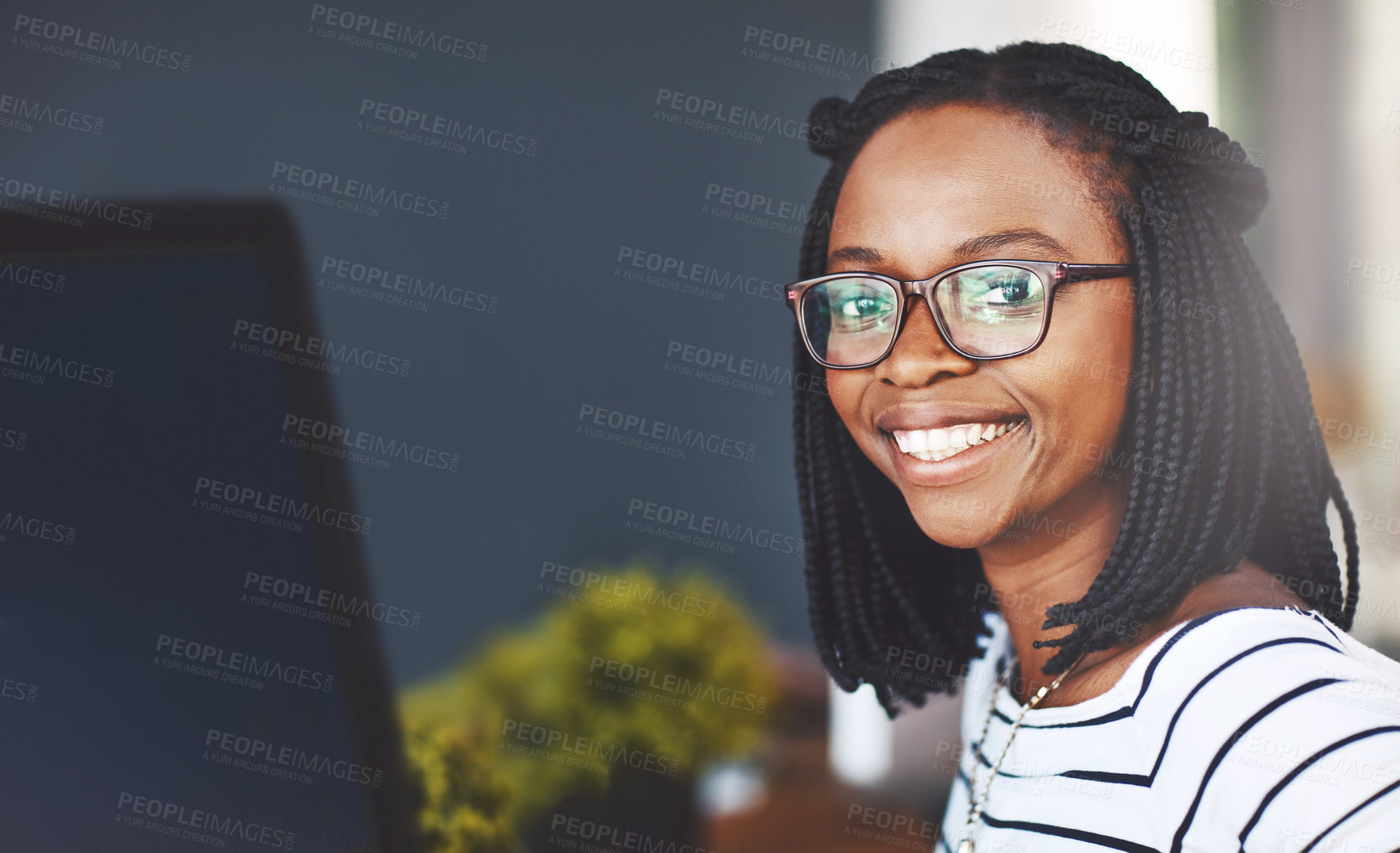 Buy stock photo Portrait of a young businesswoman working on a computer in an office