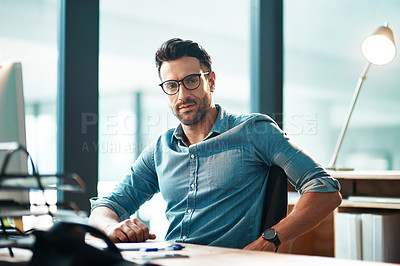 Buy stock photo Creative entrepreneur working on computer in office after researching, browsing or searching online for startup company ideas. Portrait of confident, serious or ambitious business man sitting at desk