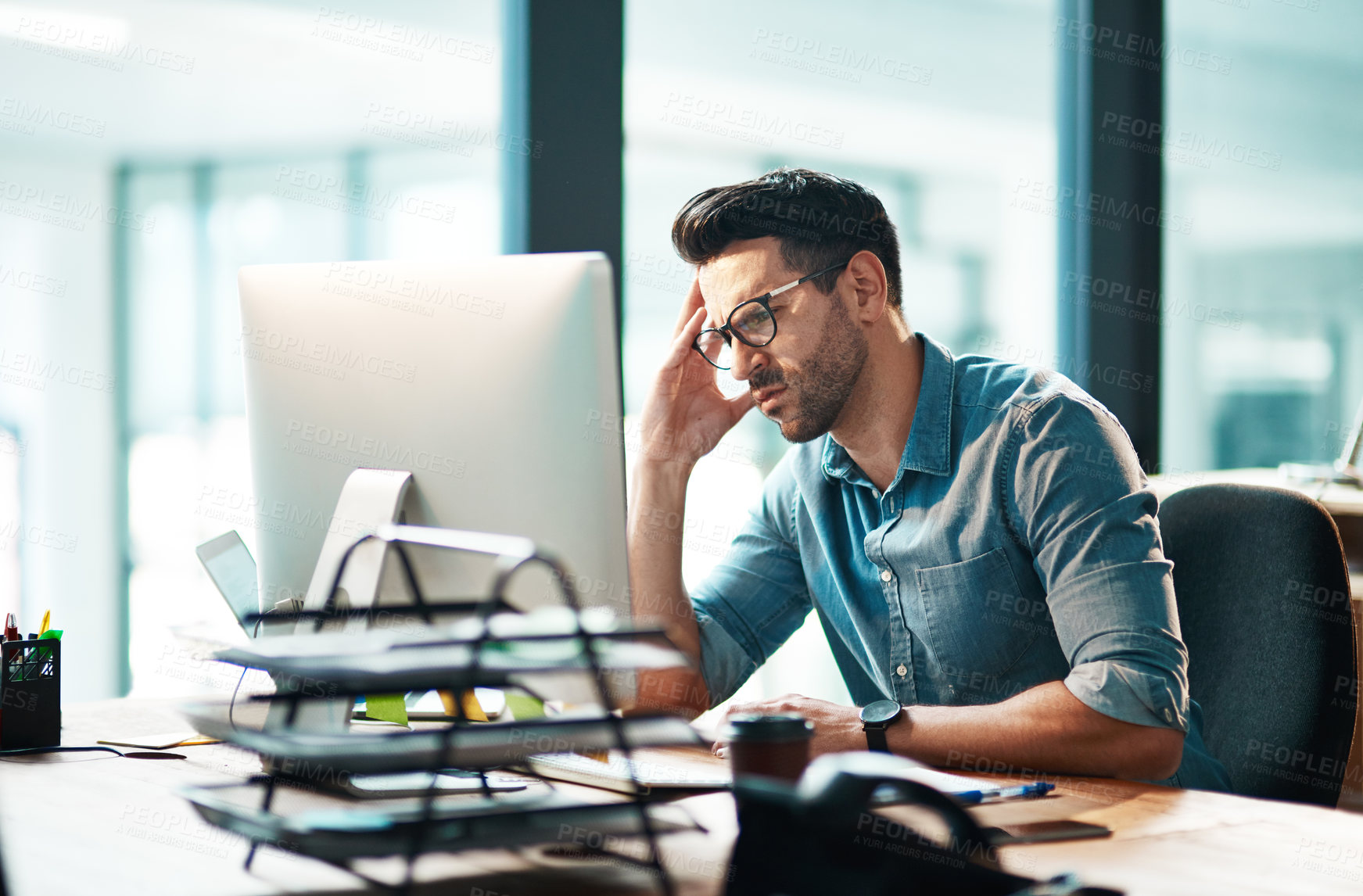 Buy stock photo Stress, anxiety and worry with a business man feeling frustrated, irritated and annoyed with work and deadlines. Unhappy and negative male employee suffering from a headache or migraine in his office