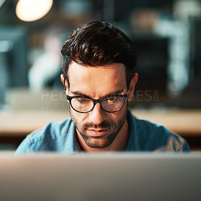 Buy stock photo Focused man, face and glasses at computer in office for planning strategy, online research and reading email at night. Serious worker, desktop pc and website connection for business, internet or tech