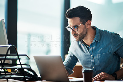 Buy stock photo Serious, business man and laptop in office for planning, online research or developer reading data at desk. Focused worker, computer and website connection for digital project, internet or technology