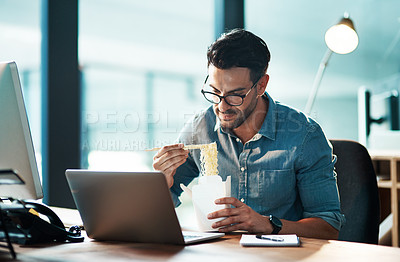 Buy stock photo Business man eating lunch at his desk, reading an email on a laptop and working overtime in office. Corporate professional, manager or employee completing a deadline and browsing internet for ideas