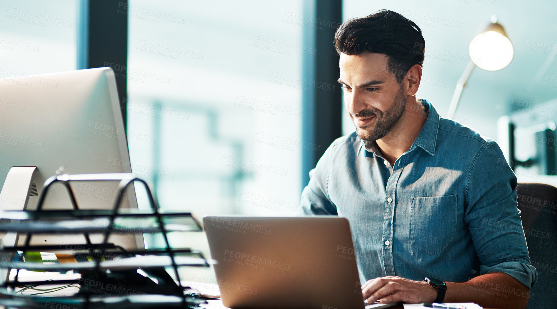 Buy stock photo Business man with laptop working late at night, browsing and searching online while planning, researching or typing office deadline. Smiling, happy and confident entrepreneur feeling proud of startup