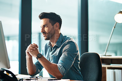 Buy stock photo Serious, busy and thinking business man working at his computer desk alone inside a modern office near a window. Worried entrepreneur, manager or boss reading emails and looking stressed 