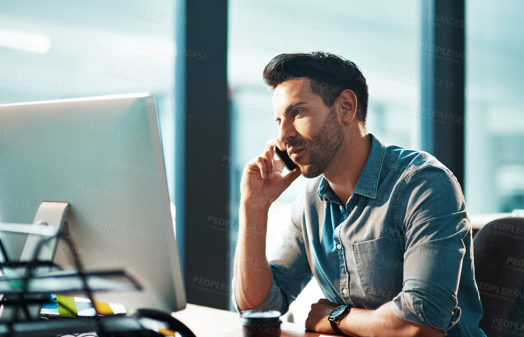 Buy stock photo Serious man, phone call and computer in office for conversation, communication and planning contact. Employee talking on cellphone at desktop for mobile networking, consulting and business feedback