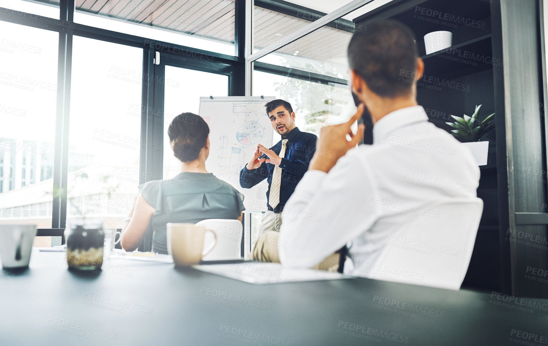 Buy stock photo Shot of a group of corporate businesspeople meeting in the boardroom