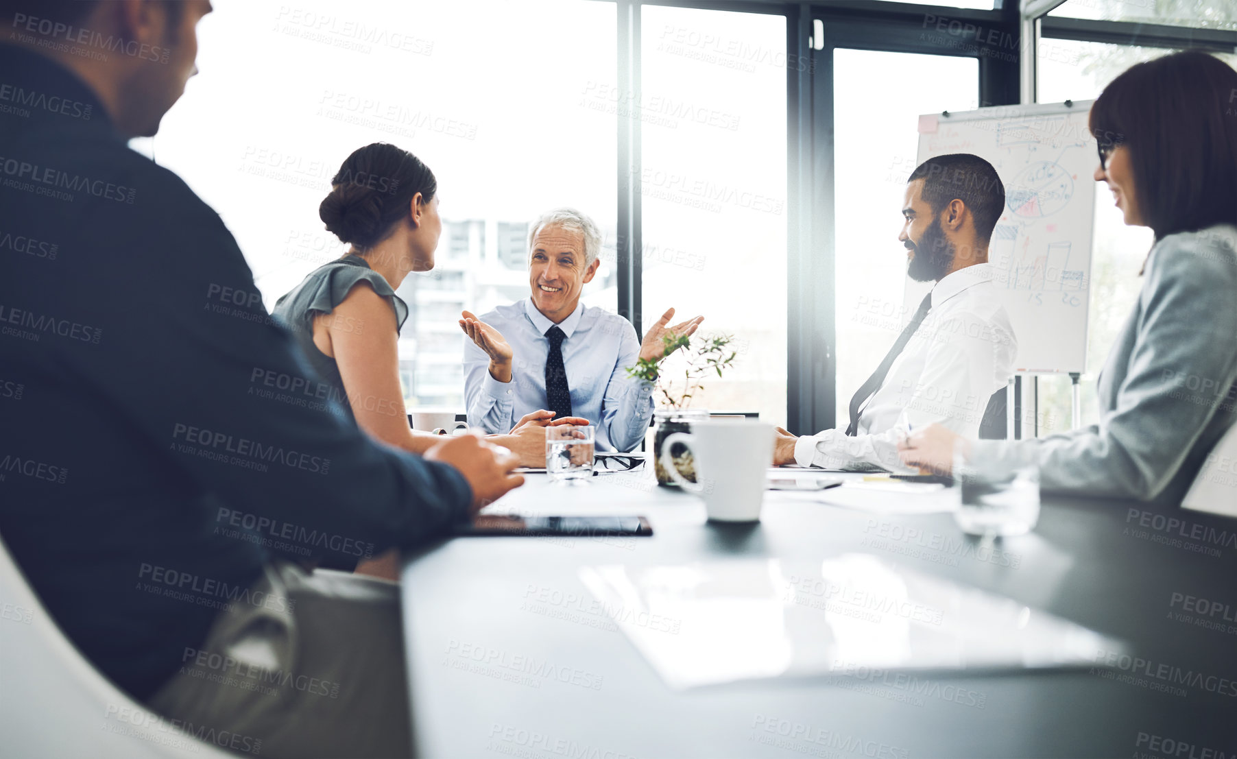 Buy stock photo Shot of a group of corporate businesspeople meeting in the boardroom