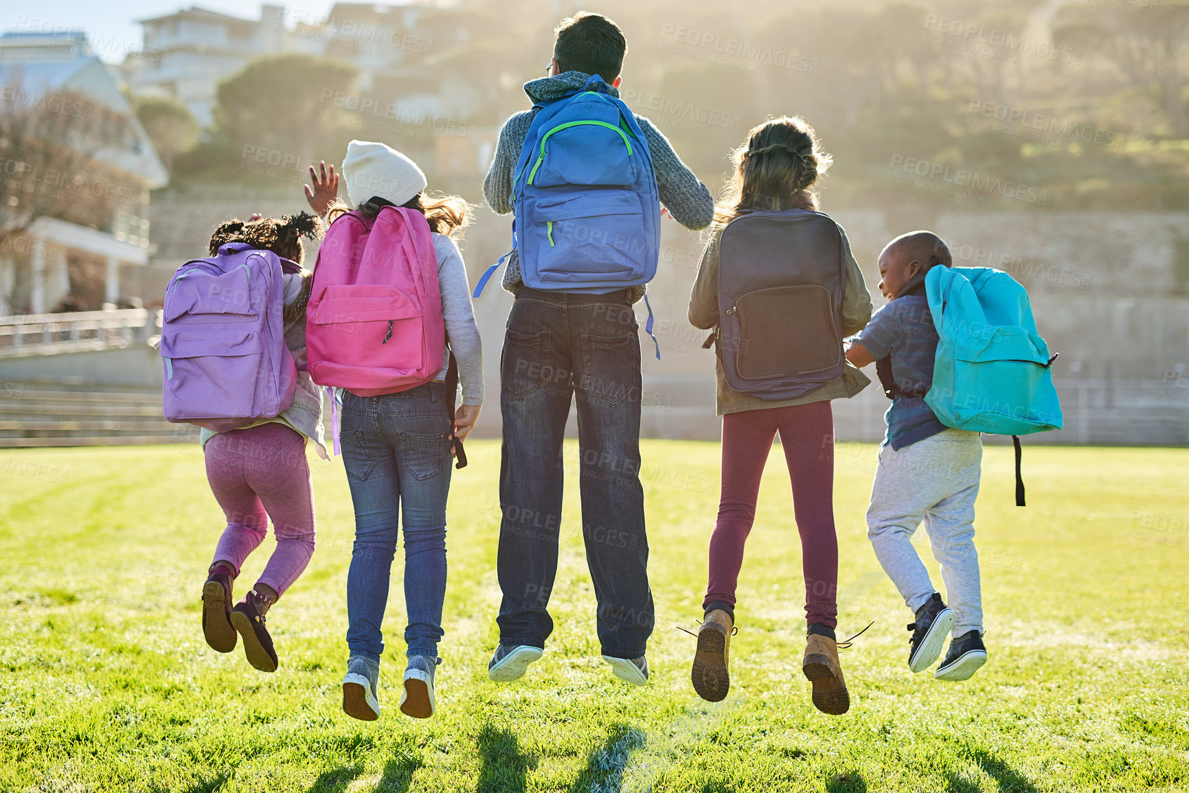Buy stock photo Rearview shot of a group of elementary school kids playing together outdoors