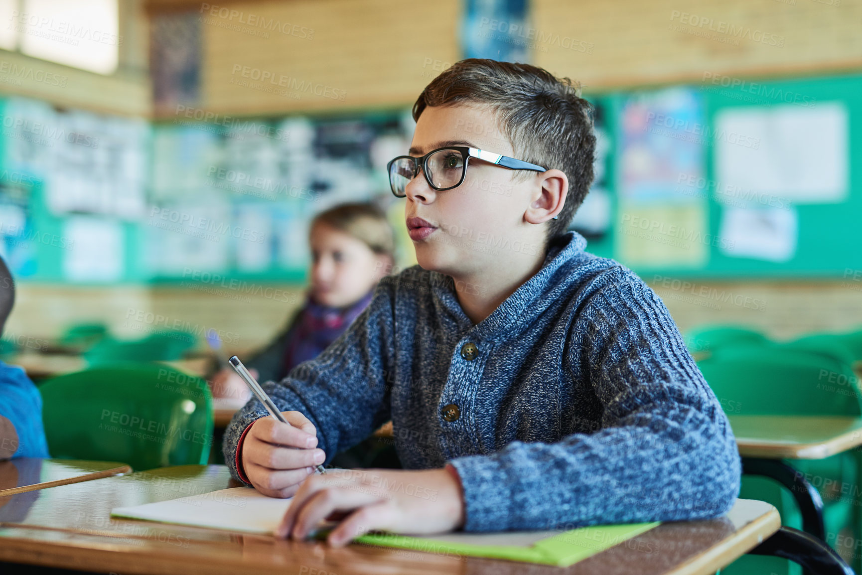 Buy stock photo Boy, child and writing with book in classroom for learning, listen and development for education. Kid, notebook and thinking with information, scholarship and study with progress for future at school