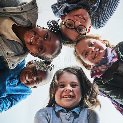 Buy stock photo Portrait of a group of elementary school kids standing in a huddle