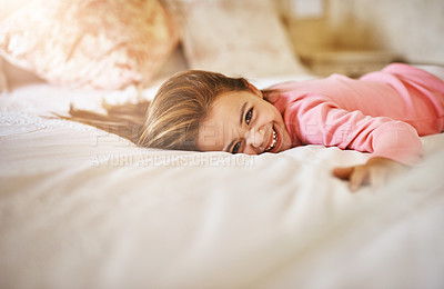 Buy stock photo Shot of a little girl lying on bed