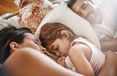 Buy stock photo Shot of a family sleeping in bed at home 