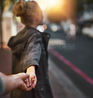 Buy stock photo Shot of a young woman pulling on her boyfriend's hand