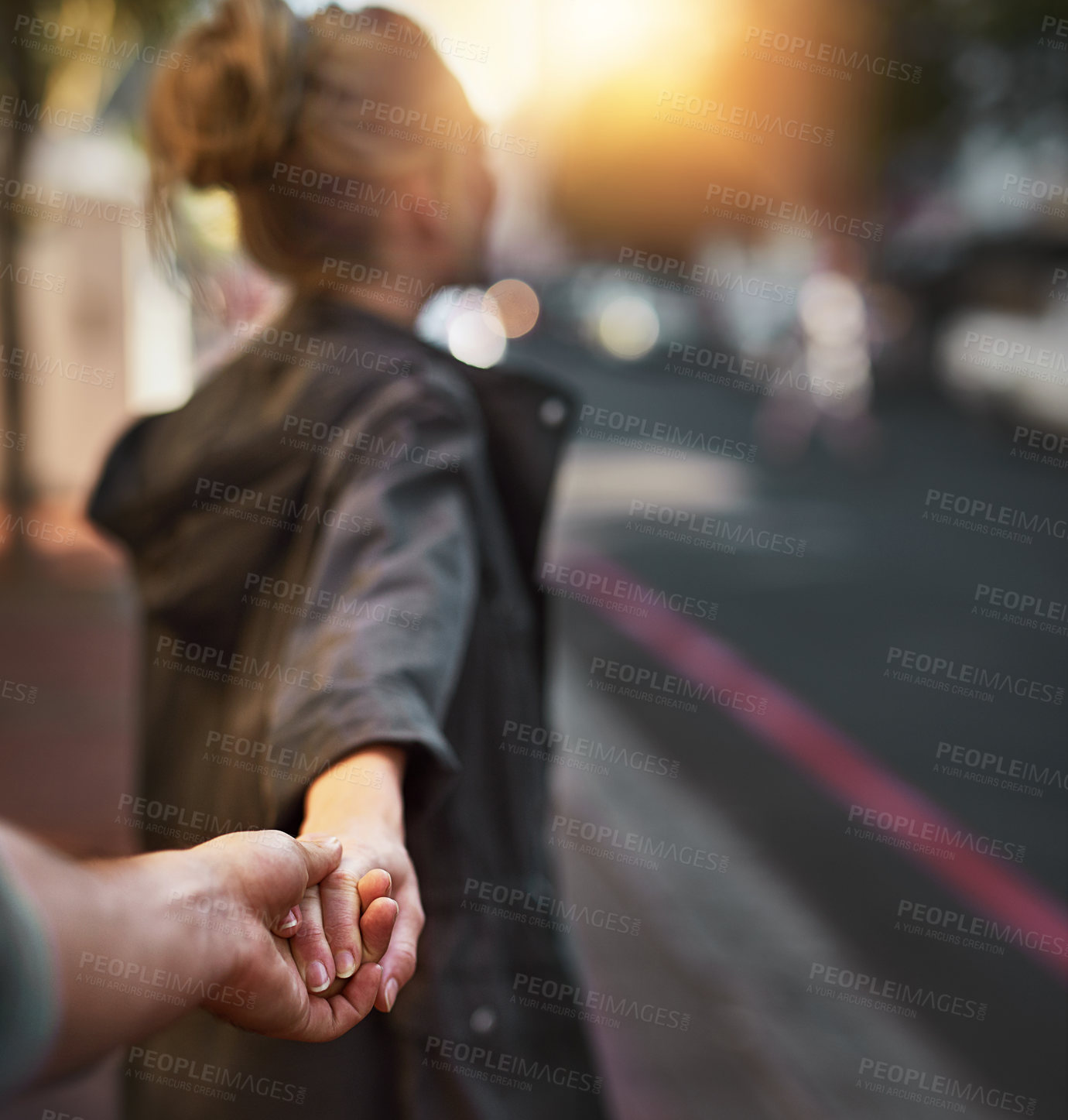 Buy stock photo Shot of a young woman pulling on her boyfriend's hand