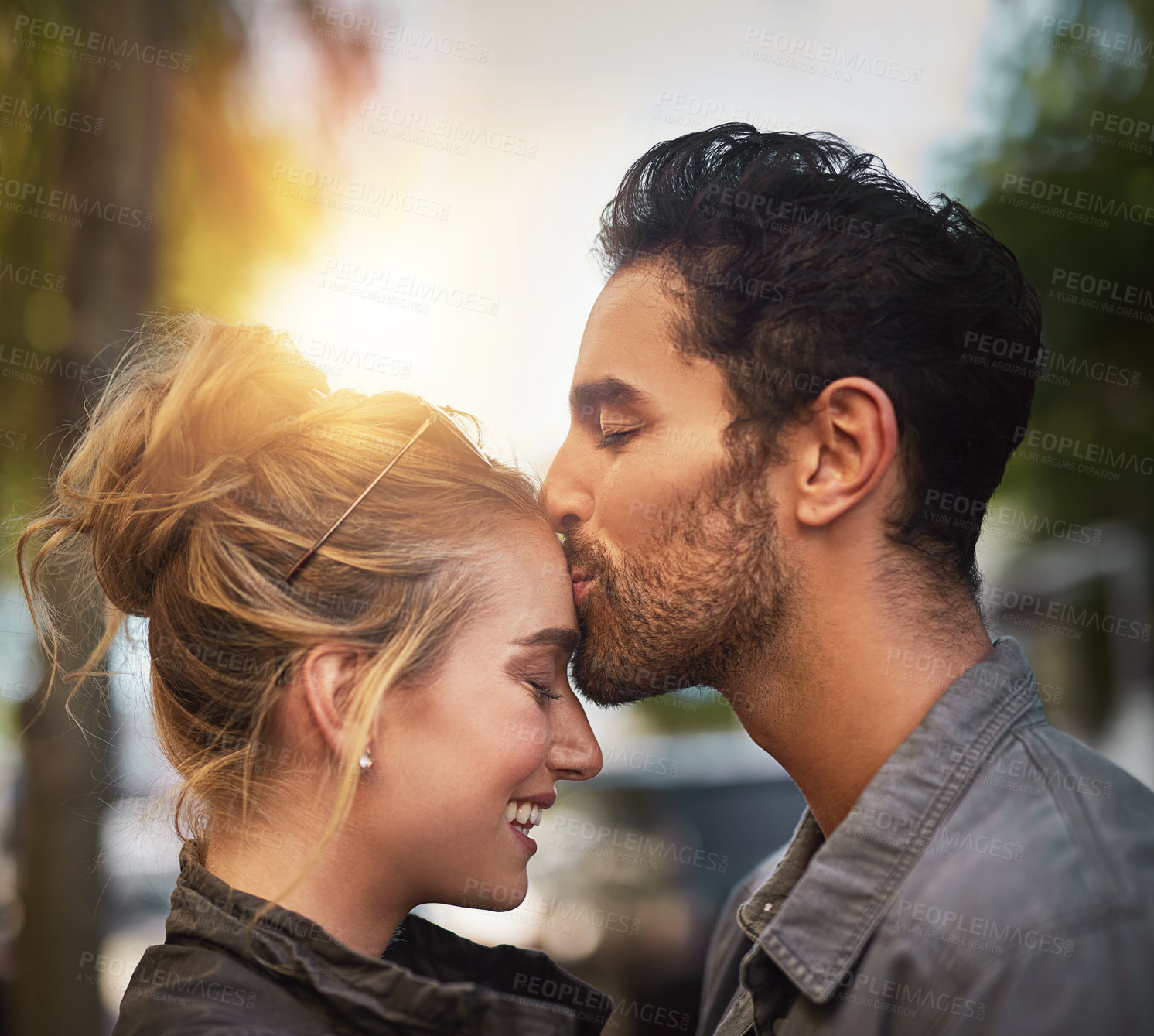 Buy stock photo Love, couple and forehead kiss in vacation, adventure and bonding together in California by flare. Happy people, boyfriend and girlfriend in relationship, dating and affection with care outdoor