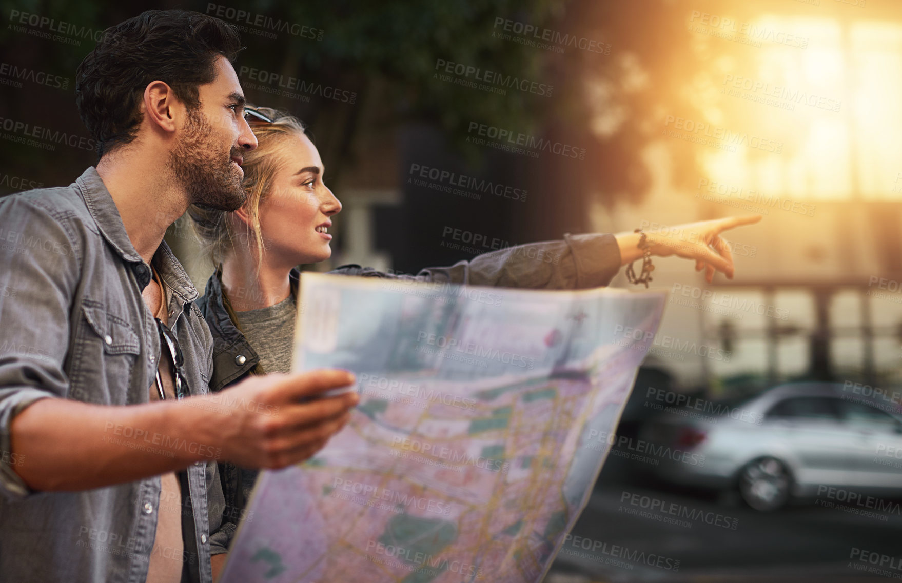 Buy stock photo Couple, map and point in street for travel, direction and search for building on holiday in city. People, man and woman with paper chart for landmark, location and outdoor on urban sidewalk in Berlin