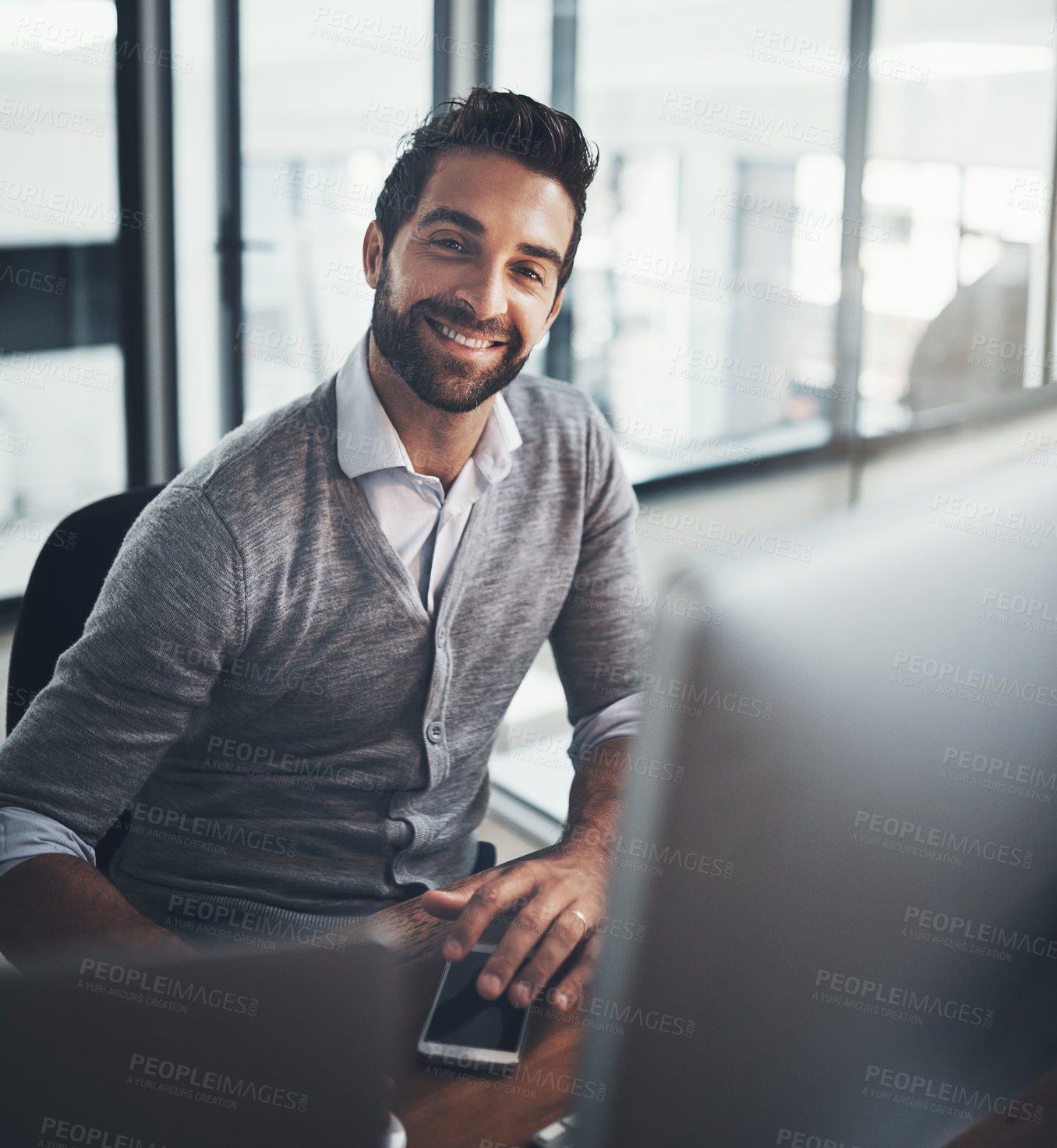 Buy stock photo Portrait of a young businessman working on a computer in an office