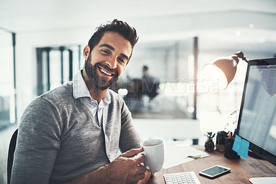 Buy stock photo Portrait of a young businessman drinking coffee while working in an office