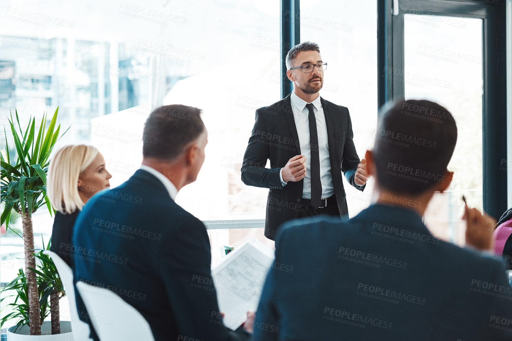 Buy stock photo Cropped shot of a handsome mature businessman giving a presentation in the boardroom