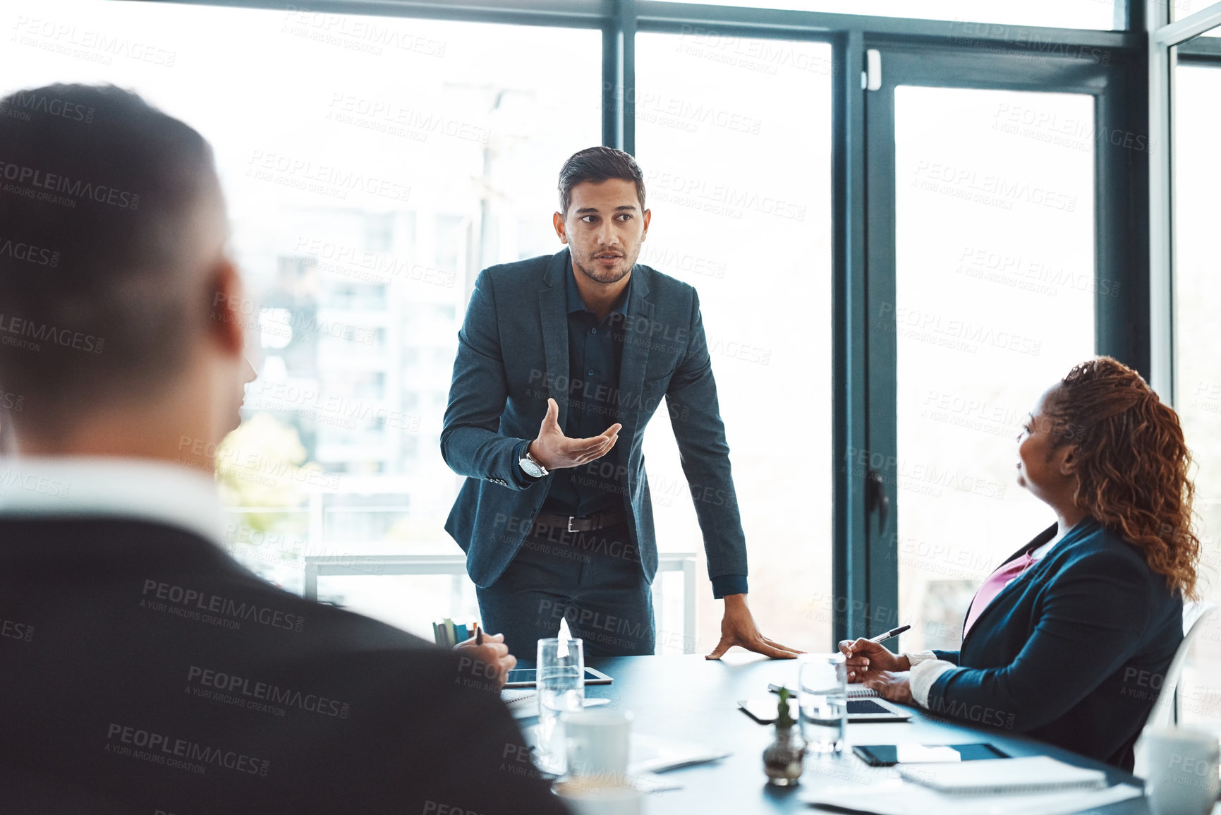 Buy stock photo Cropped shot of a handsome young businessman giving a presentation in the boardroom